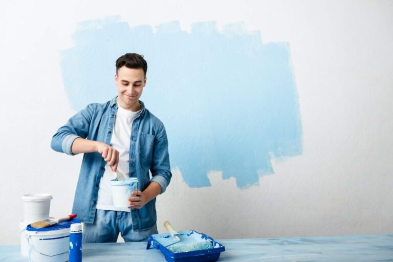 Happy guy mixes pigment for paint wall